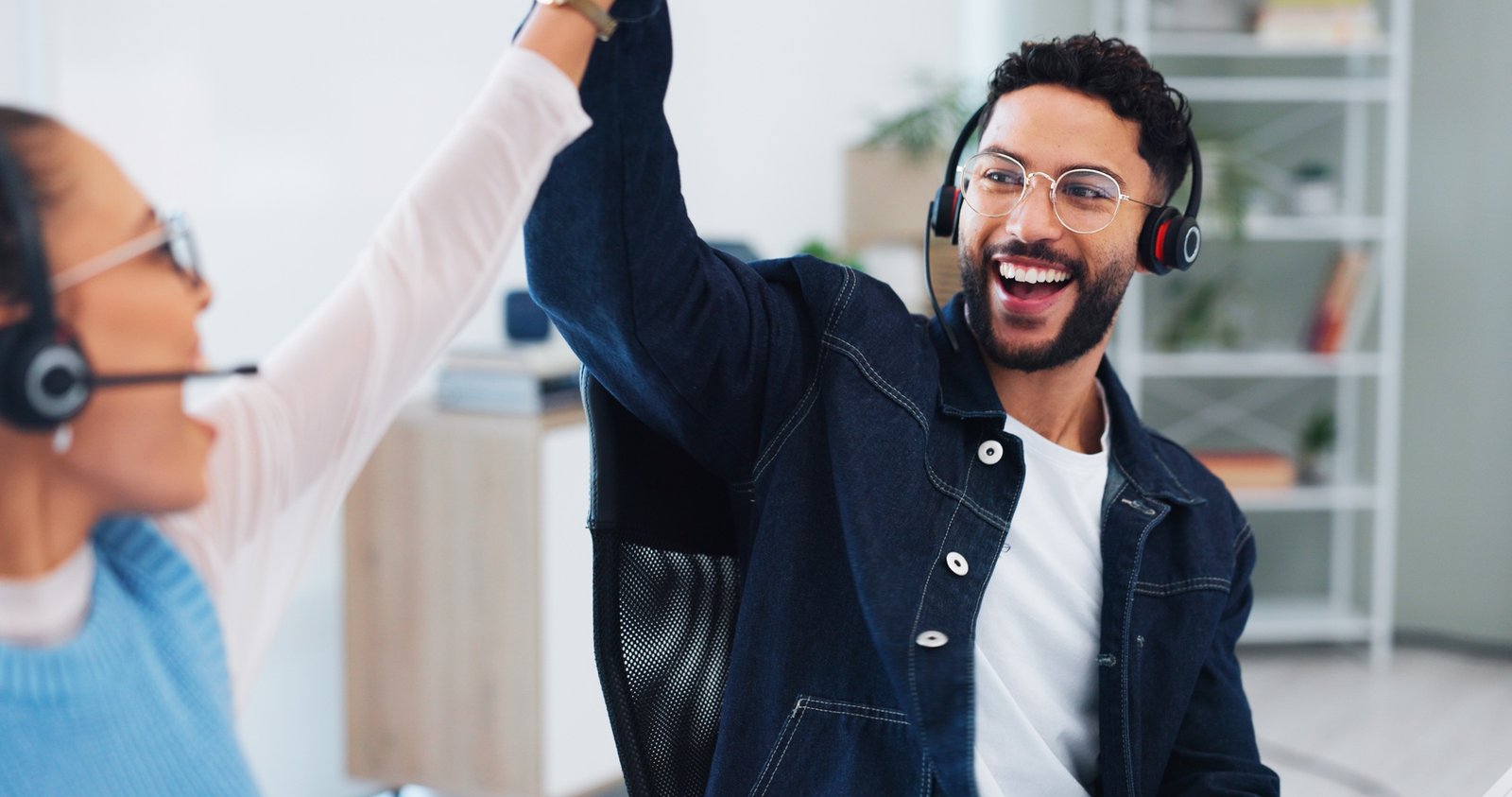 Happy, business people and high five with headset in call center for telecom, motivation and suppor